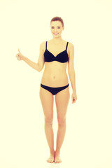 Woman in bikini with thumbs up.