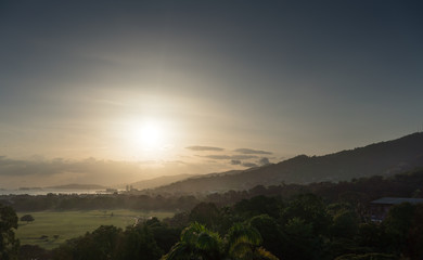 Scenic view of forest during sunrise with mountain in background, Trinidad, Trinidad And Tobago