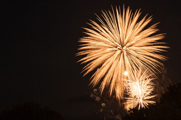 Fototapeta premium Illuminated firework display against sky at night