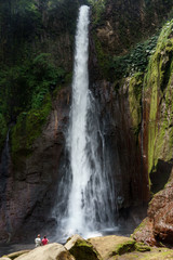 Tourist in La Fortuna Waterfall in a forest, Alajuela Province, Costa Rica
