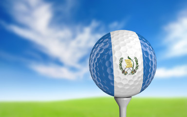 Golf ball with Guatemala flag colors sitting on a tee