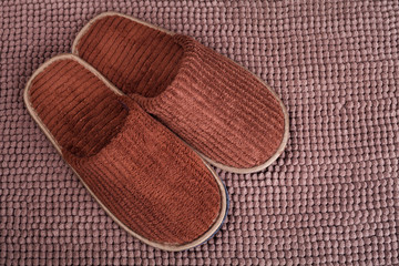 Brown wool slipper on mat