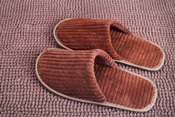 Brown wool slipper on mat