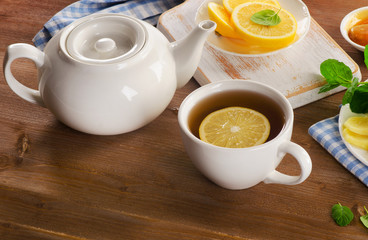 Tea with lemon on a wooden board