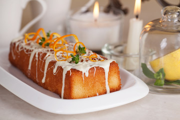 plum cake food white chocolate, orange zest, thyme, close-up still life with tea and lemon