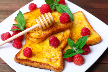 delicious French toast with raspberries and honey