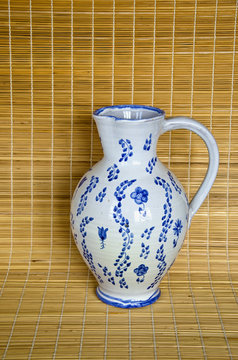 Clay jug on bamboo material background