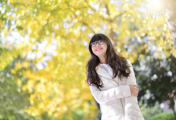 Pretty Chinese girl dresses down coat in the sunshine day