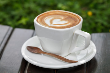 Close-up cup of latte coffee on wooden (Selective focus)