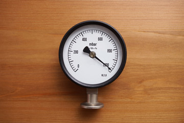 pressure gauge on wood background