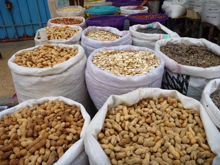 white bags with colorful spices and nuts at the market