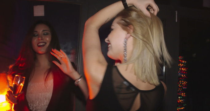 Two charming female friends enjoying party night