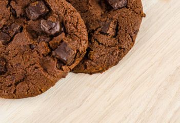 Chocolate cookies on wooden table.