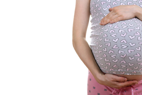 a pregnant woman in pyjamas supports hand belly on a white isolated background