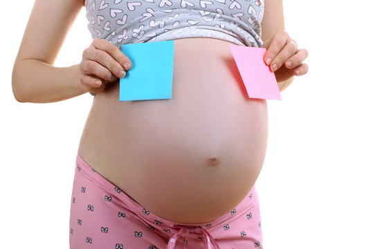 a pregnant woman in pyjamas holding a blue and pink paper isolated on white background