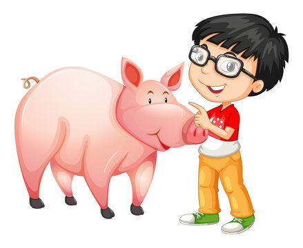 Little boy standing next to a pig