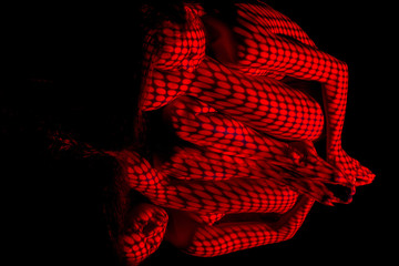 The  body of woman with red pattern and its reflection