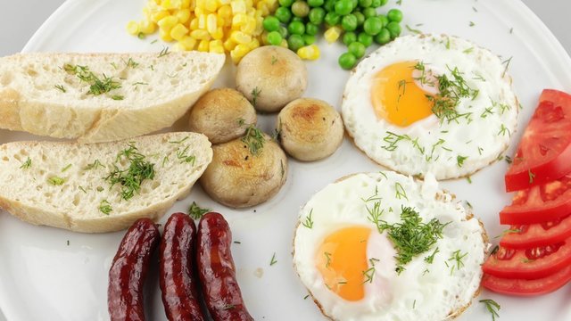 Full breakfast with scrambled eggs, sausages and vegetables (loop)