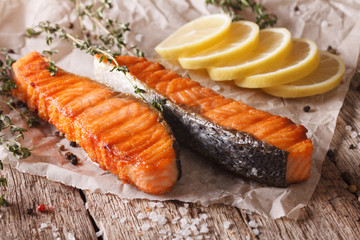 Homemade Grilled salmon with lemon on a paper closeup. horizontal
