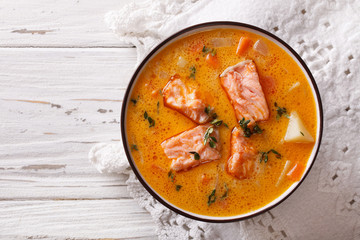 salmon soup with vegetables and thyme. horizontal top view
