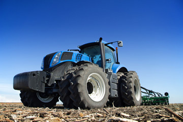 Powerful tractor working in the field