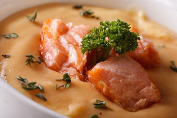 Thick soup puree of red fish macro in a bowl. horizontal
