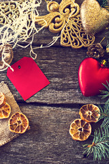 Christmas composition. Fir branches and Christmas decorations on a background of wooden boards