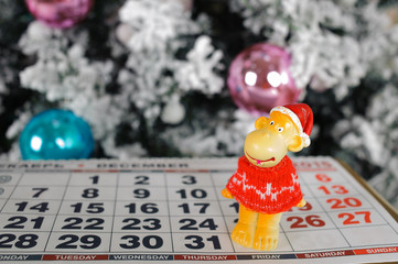 the symbol of the new 2016 monkey on the calendar on the background of Christmas tree