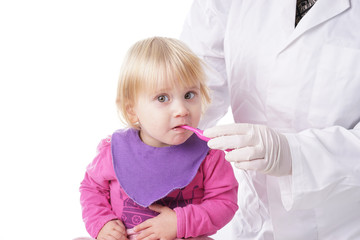 Baby girl gets help by the Dentist to brush her teeth
