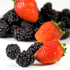 Isolated image of ripe blackberry and strawberry closeup