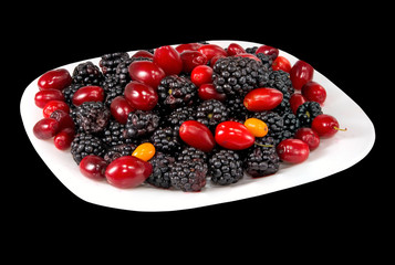 image of dogwood and blackberry on a plate on a black background