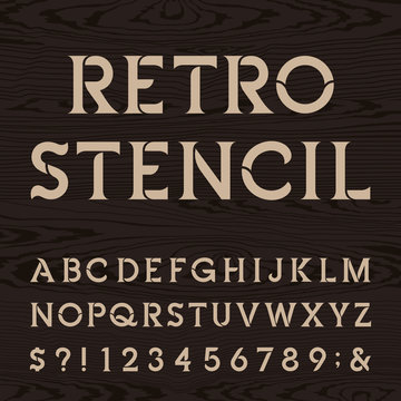 Retro alphabet vector stencil font. Letters, numbers and symbols on the dark wood textured background. Vintage vector typography for labels, headlines, posters etc.