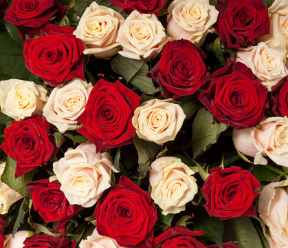 Big red and yellow roses bouquet background, top view