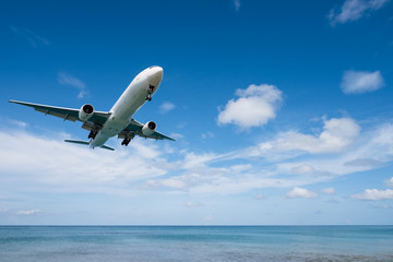 Fototapeta premium Airplane landing from sea to airport