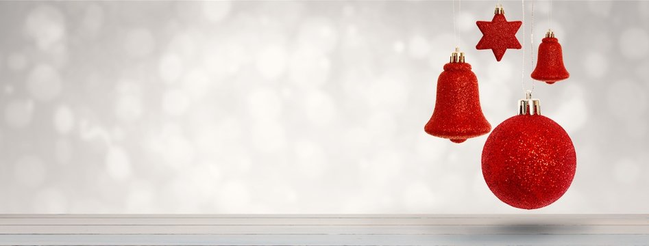 Composite image of red christmas bell decoration hanging 
