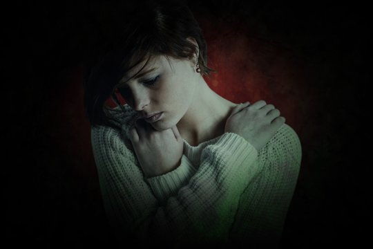 Composite image of sad brunette thinking with arms crossed