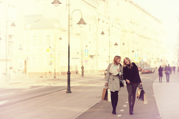 Spring sunny portrait of two friends in the city girl for a walk