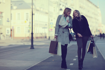 two cheerful blonde for a walk in the city