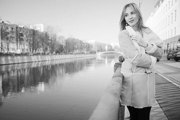 black and white portrait of a woman walking in the city