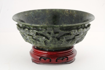 Jade bowl with wooden base isolated on white background