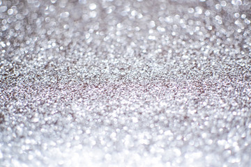 Blurry abstract bokeh lights on grey background with sparkle.