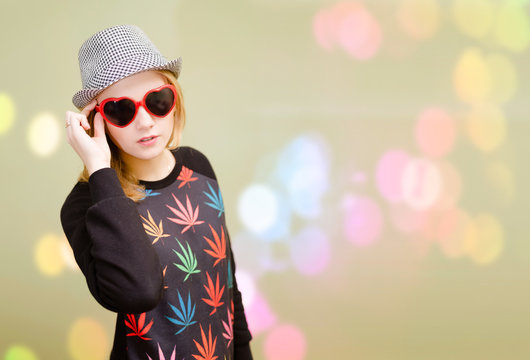 Pretty girl in fancy sunglasses on colorful bokeh blurred background