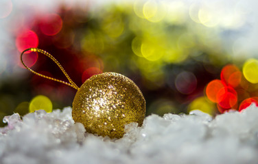 Gold Christmas Ball on defocused lights background 