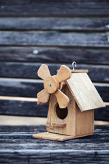 bird house on grunge wooden panel