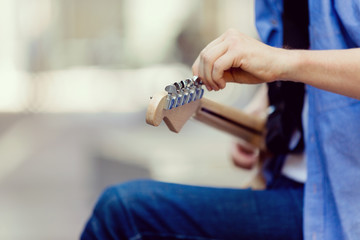 Hands of musician with guitar