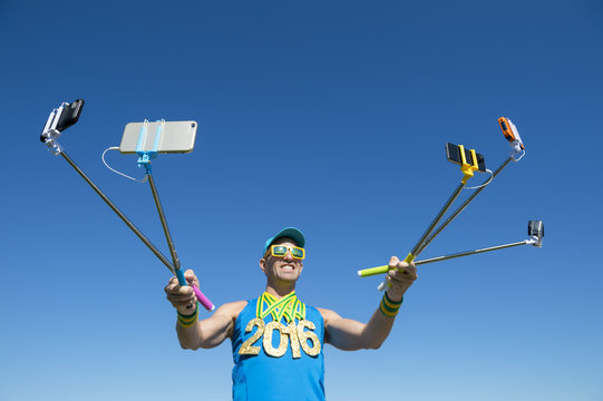 Gold medal 2016 athlete making a face for his many gadgets on selfie sticks as he poses for photos