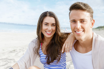 Romantic young couple sitting on the beach