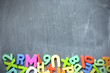 Blackboard background with colored letter blocks as frame
