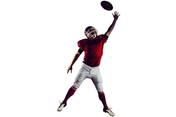 American football player trying to catch football