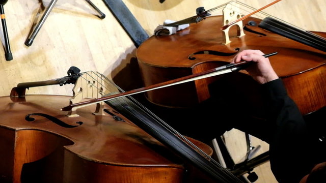 Cellist players play by Cellos - top view